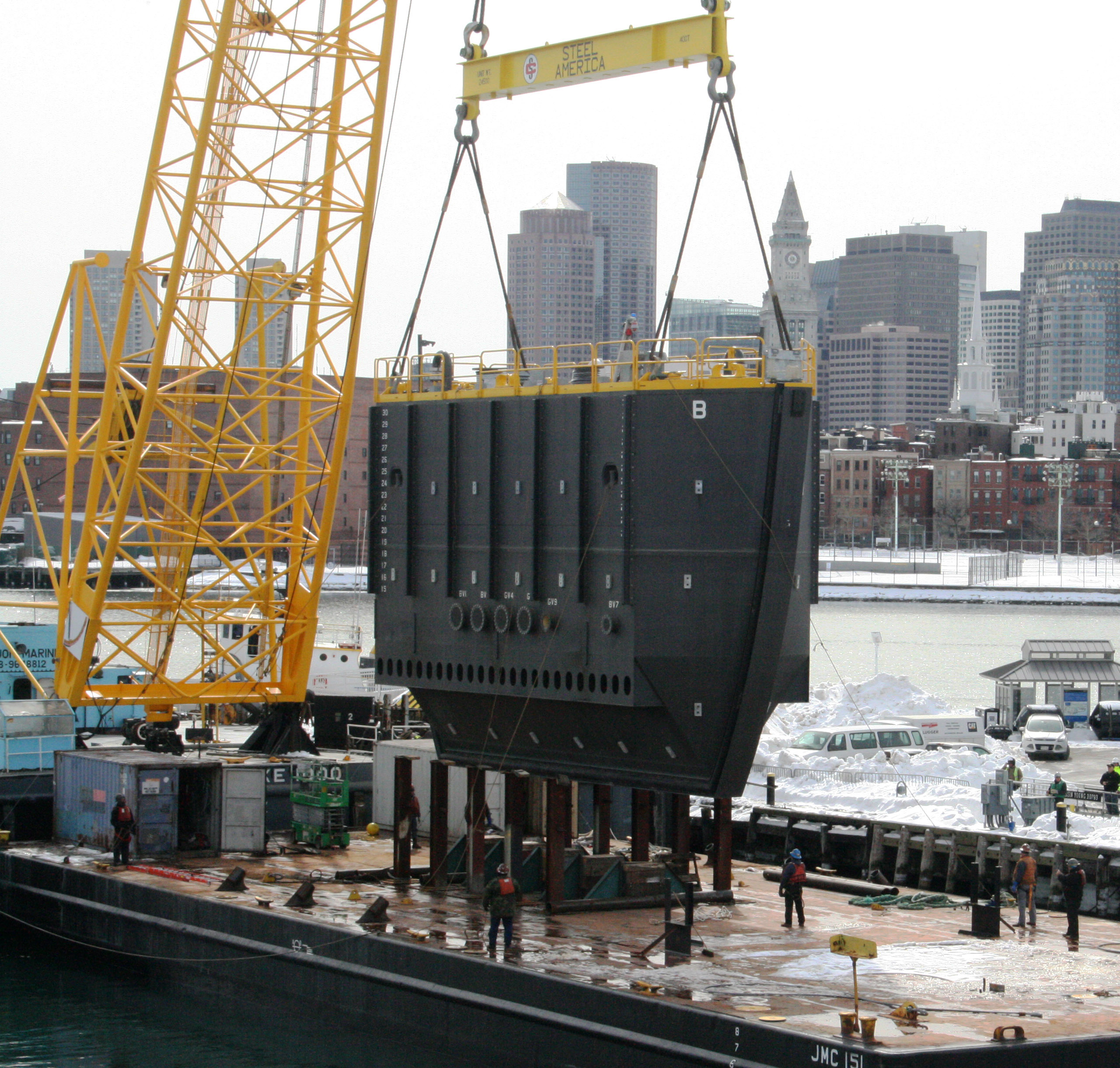The new caisson is lifted from the barge and placed into Boston Harbor, March 2015. [Courtesy Naval History & Heritage Command Detachment Boston]
