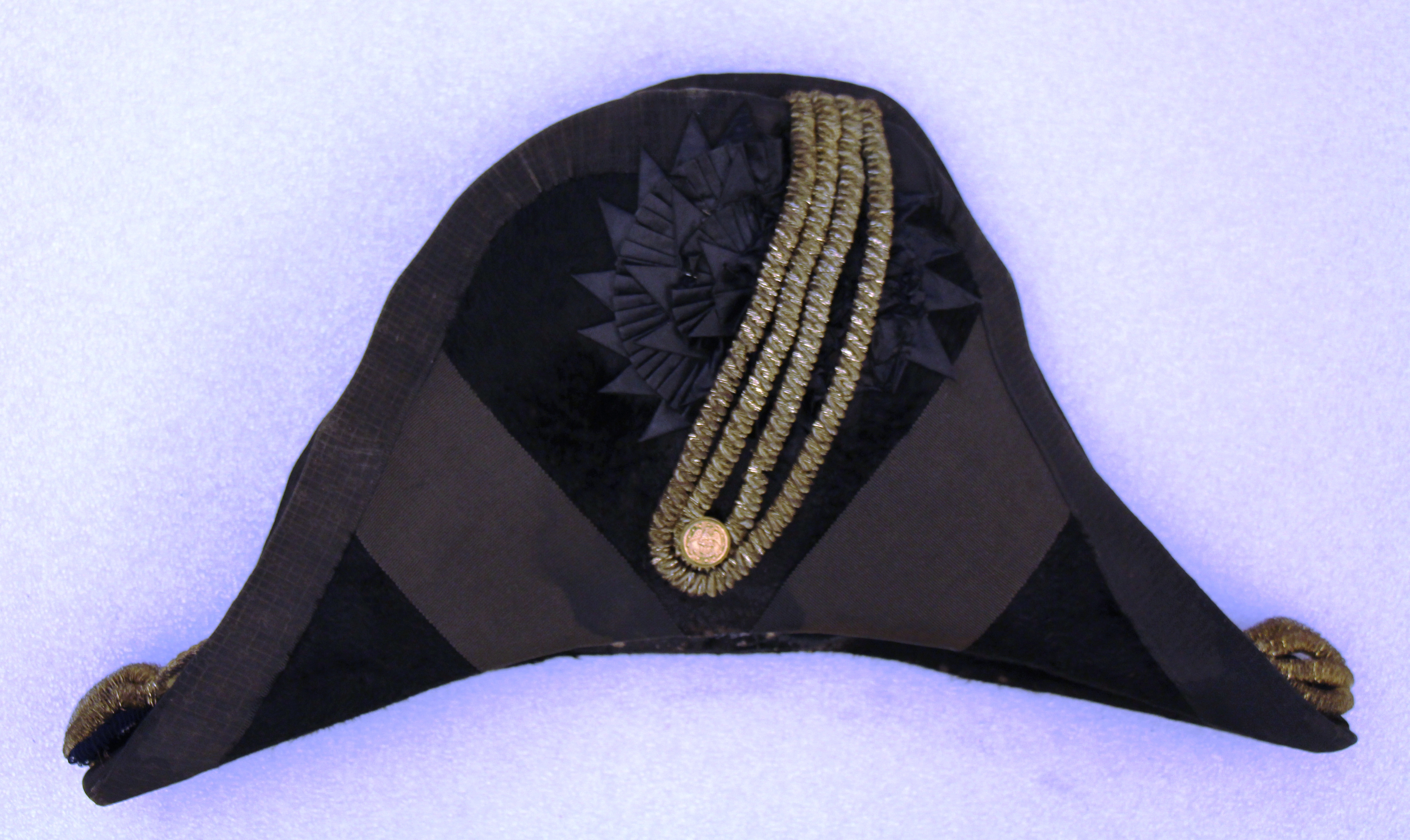A cocked hat worn by LT Wilson R. McKinney between 1846 and 1851. It closely follows the Navy uniform regulations of 1841. USS Constitution Museum collection.