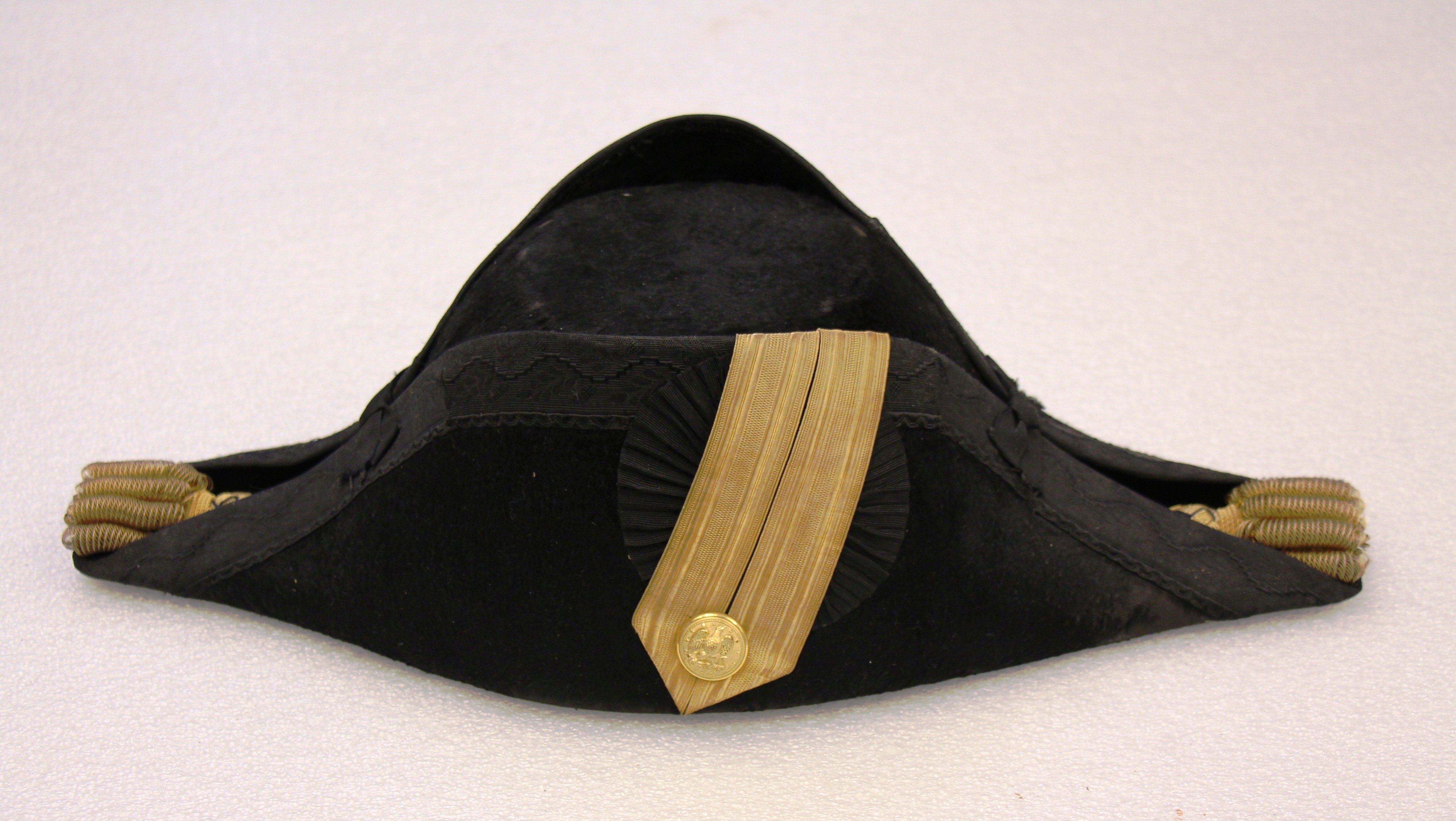 A lieutenant's cocked hat from around WWI. By this time, the details of the hat had become entirely fossilized, and remained essentially unchanged for decades.. USS Constitution Museum collection.