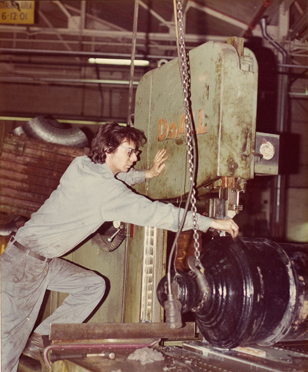 A band saw is lined up to cut the cascabel from the back of the gun at the Naval Ordinance Station in March 1976. [Courtesy Naval History & Heritage Command Detachment Boston]