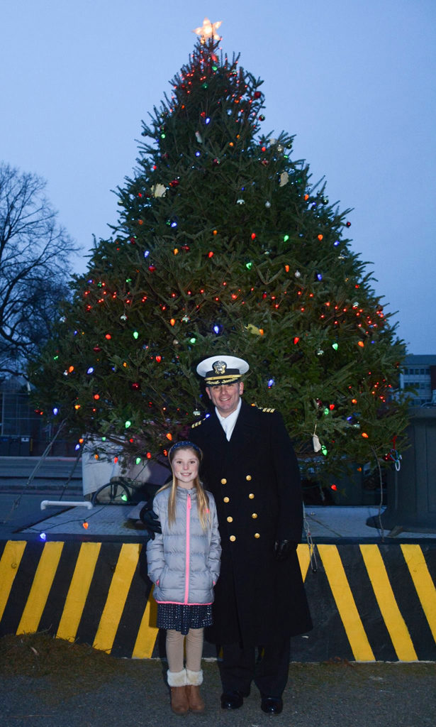 BOSTON (Dec. 11, 2016) Cmdr. Robert S. Gerosa Jr., 74th Commanding Officer of USS Constitution, poses for a photo with his daughter, Emily, during the Tree Lighting Ceremony in the Charlestoen Navy Yard. The crew of USS Constitution Hosts the Annual Tree Lighting Ceremony in the Charlestown Navy yard. (U.S. Navy photo by Petty Officer 3rd Class Erin Bullock/Released)