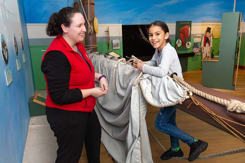 Woman and child participating in an activity at the USS Constitution Museum 