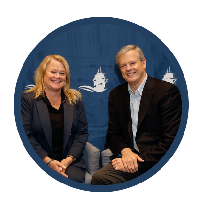 Man and Woman in business suits seated at event.